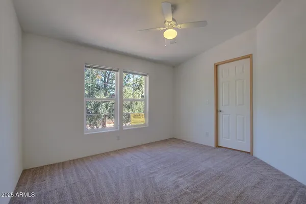 a bathroom with a granite countertop sink a toilet and a mirror