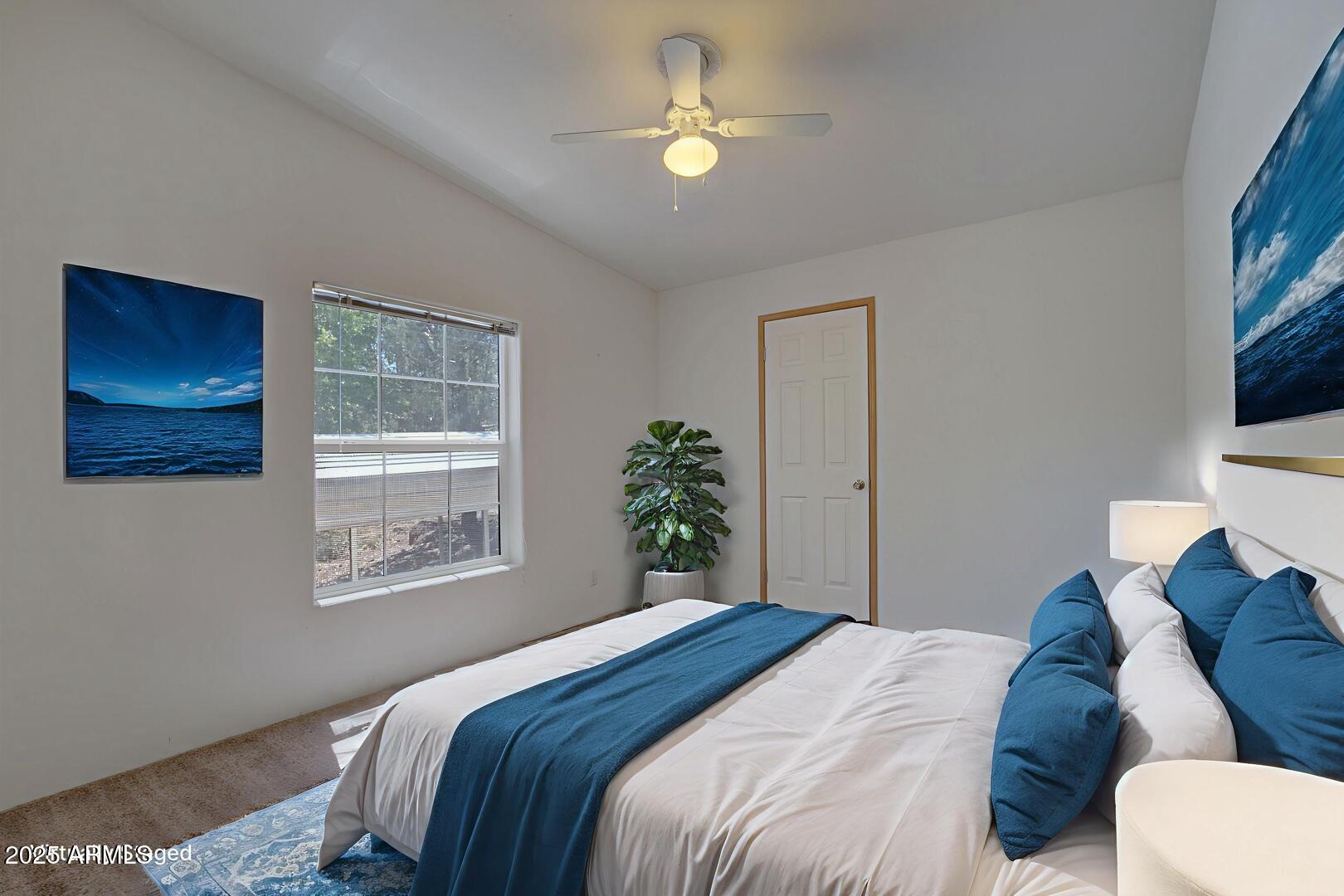 405 East Cherry Street Payson, AZ 85541 - Photo 34 of 47 a bedroom with a bed and a chandelier