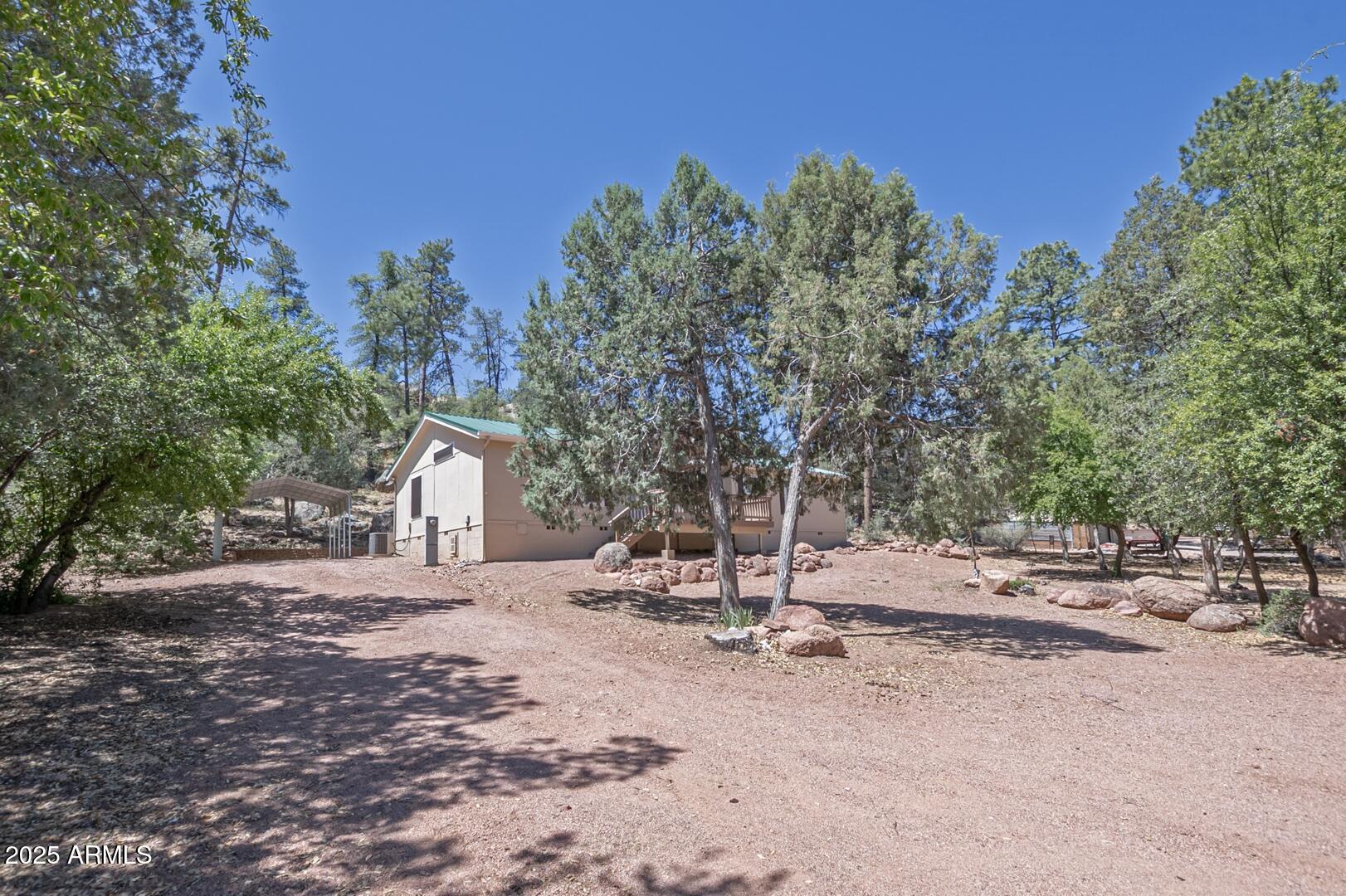 405 East Cherry Street Payson, AZ 85541 - Photo 47 of 47 a backyard of a house with table and chairs under an umbrella