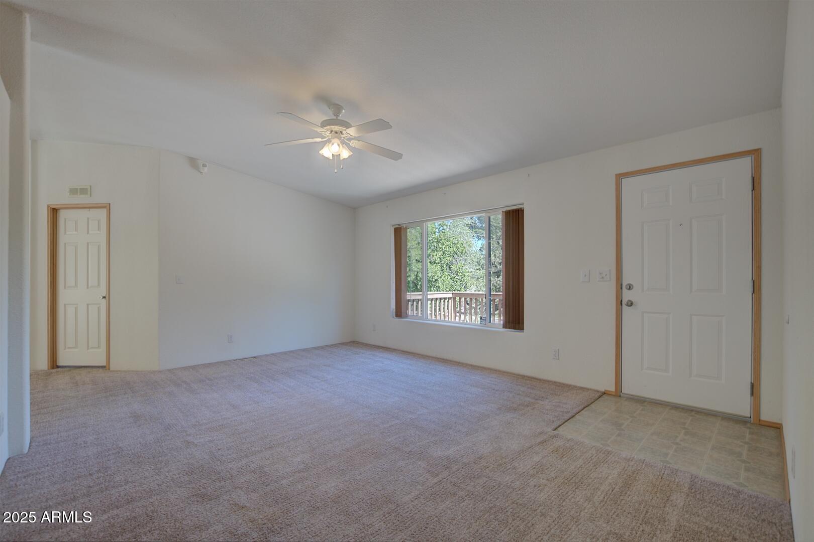 405 East Cherry Street Payson, AZ 85541 - Photo 9 of 47 an empty room with a fan & a window