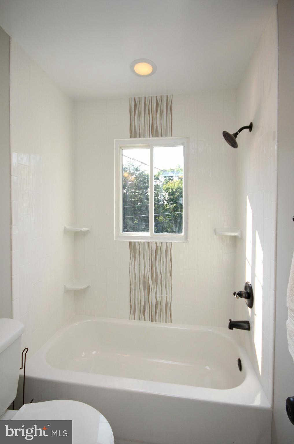 7103 Bexhill Road Baltimore, MD 21244 - Photo 14 of 30 a bathroom with a bathtub and a shower