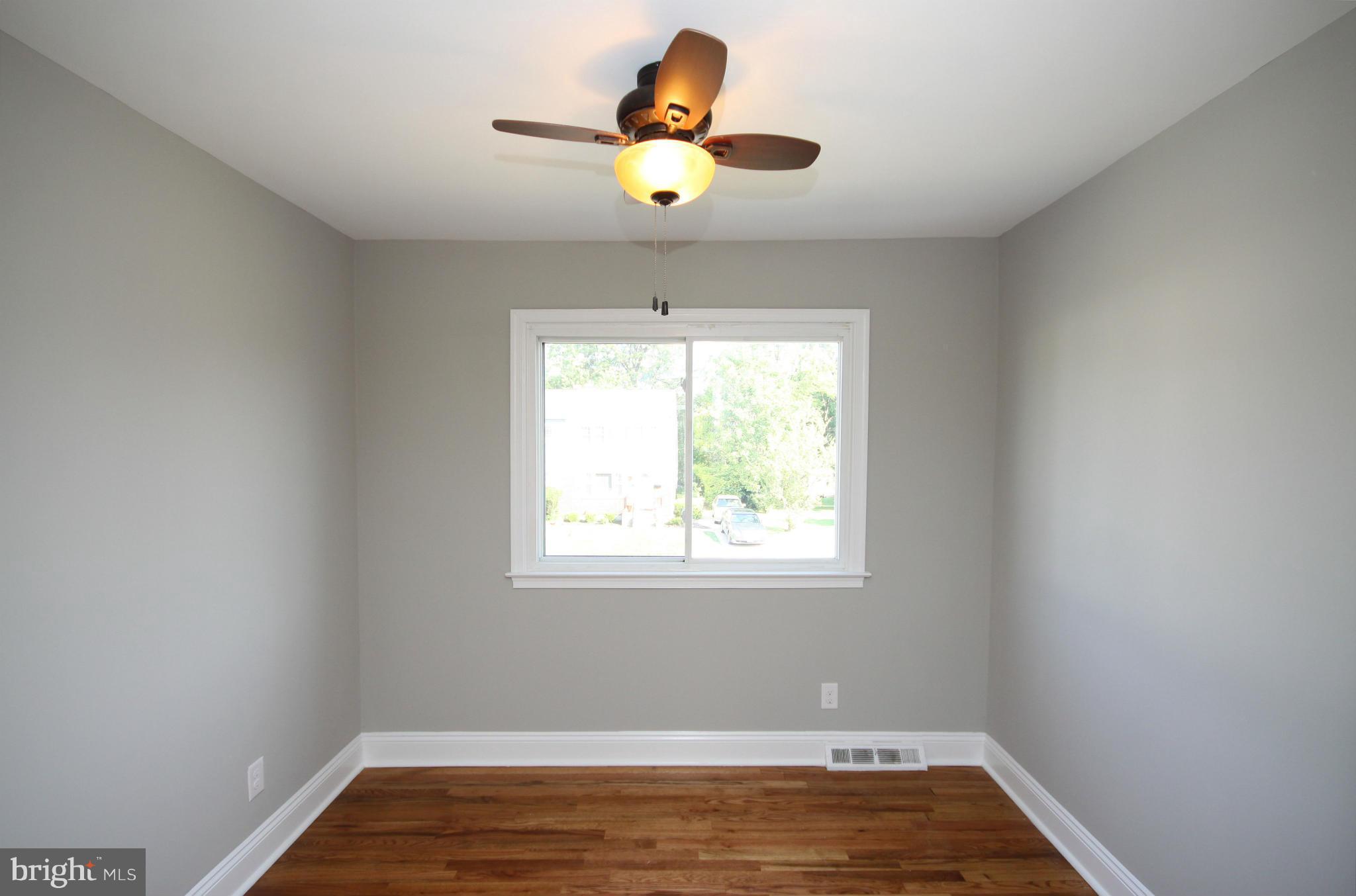 7103 Bexhill Road Baltimore, MD 21244 - Photo 18 of 30 a view of an empty room and window and wooden floor