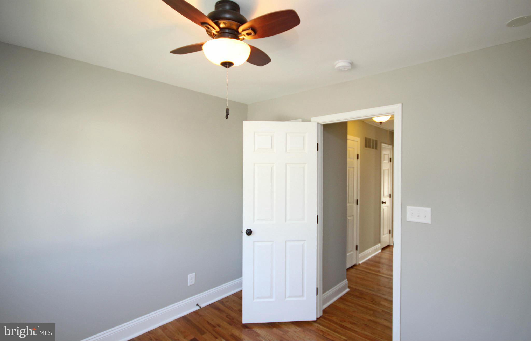 7103 Bexhill Road Baltimore, MD 21244 - Photo 19 of 30 wooden floor in an empty room
