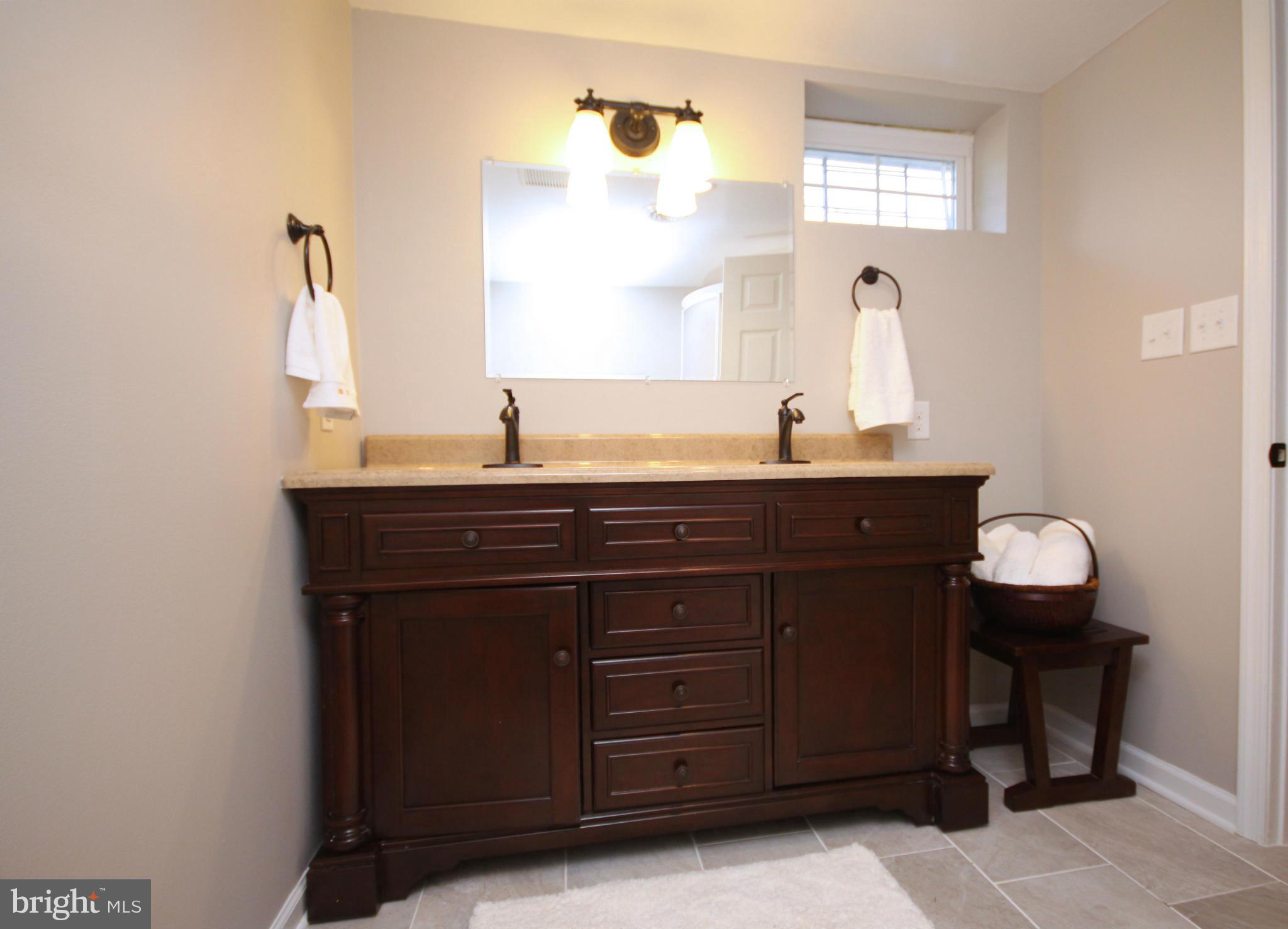 7103 Bexhill Road Baltimore, MD 21244 - Photo 23 of 30 a bathroom with a granite countertop sink and a mirror