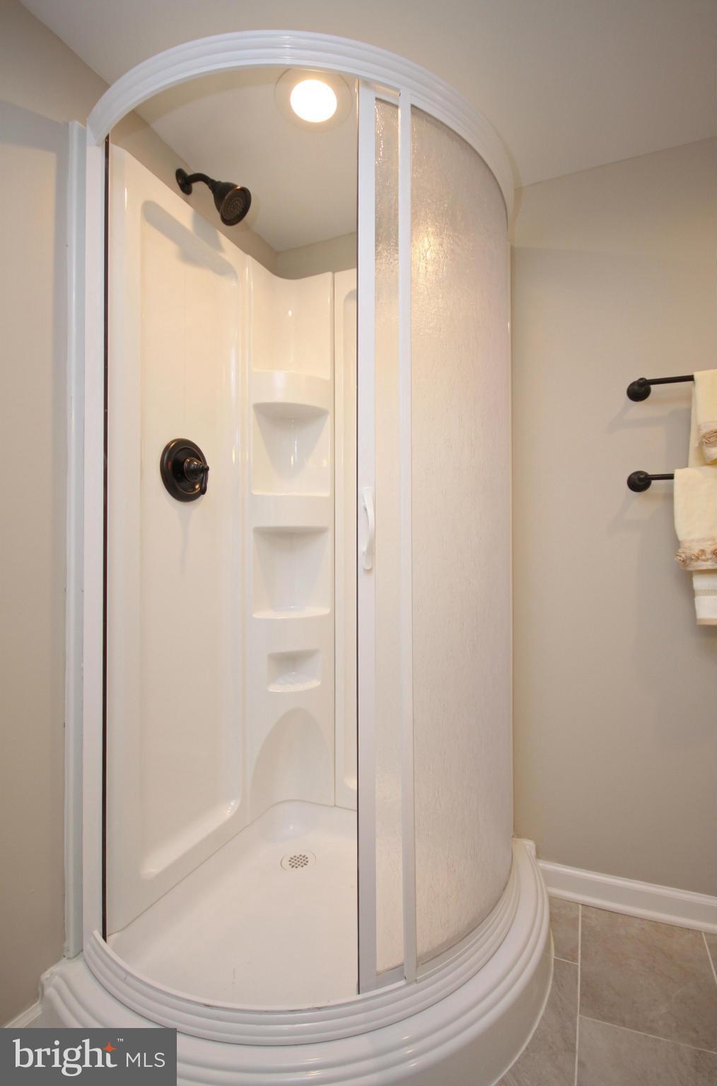 7103 Bexhill Road Baltimore, MD 21244 - Photo 24 of 30 a bathroom with a glass shower door