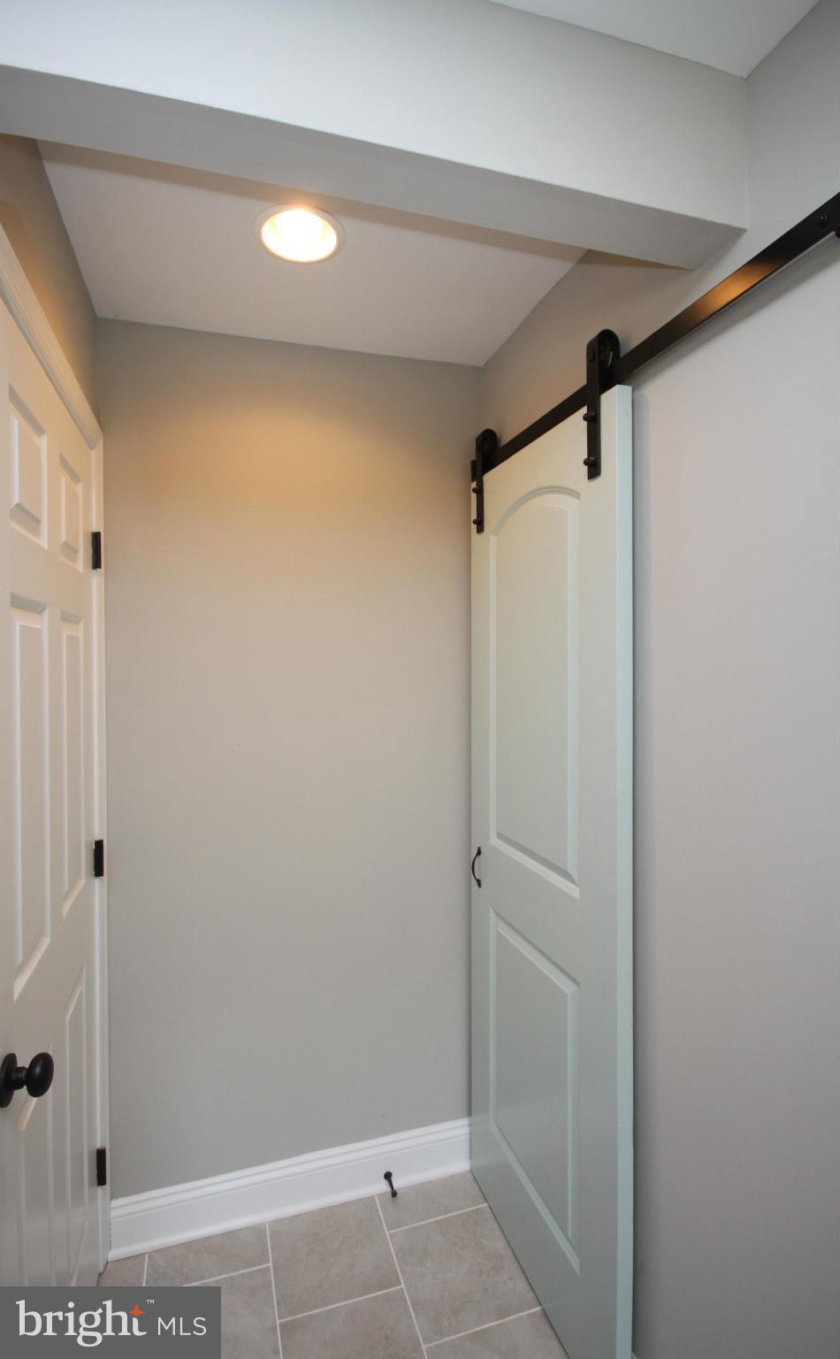 7103 Bexhill Road Baltimore, MD 21244 - Photo 5 of 30 a bathroom with a shower and a glass door