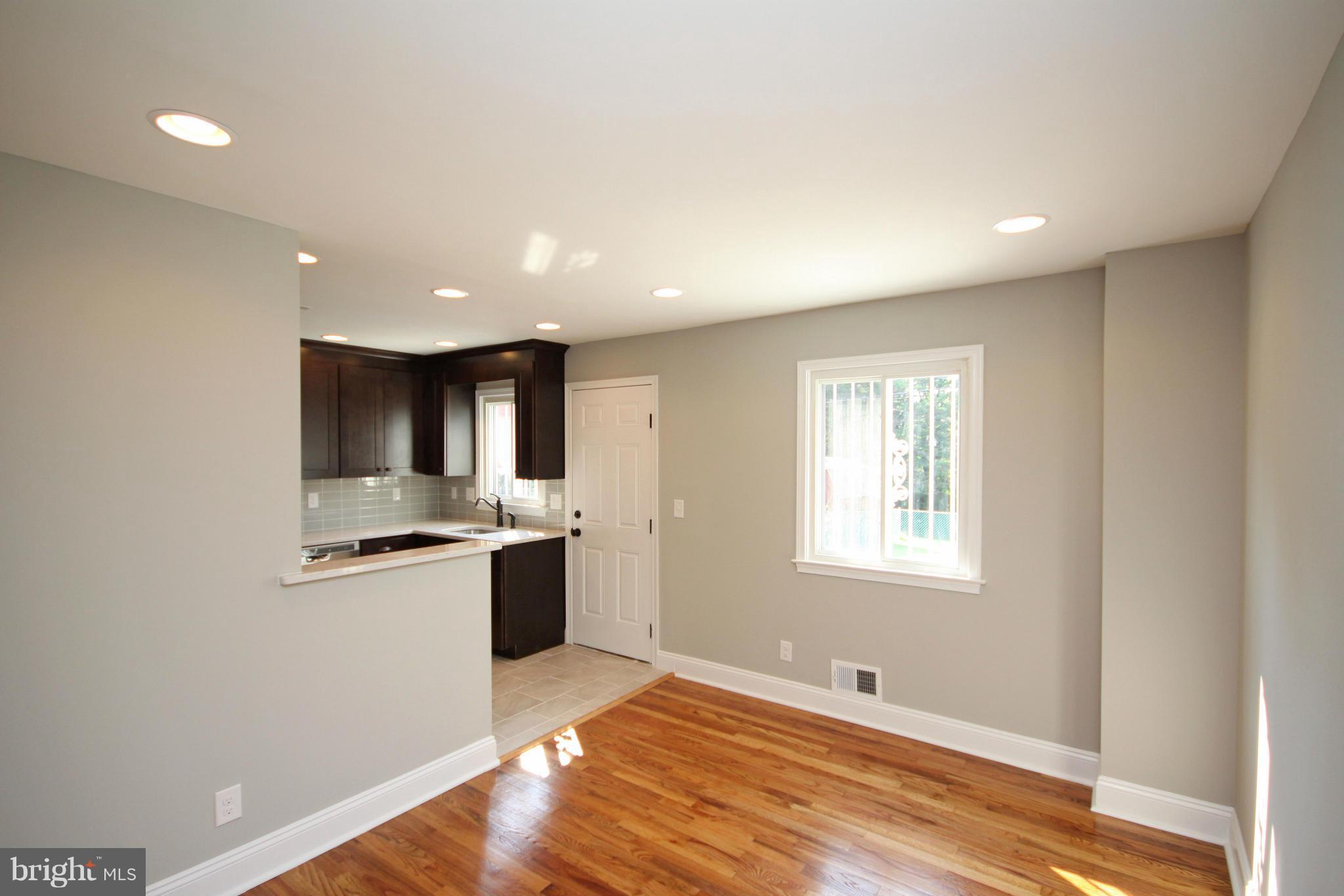 7103 Bexhill Road Baltimore, MD 21244 - Photo 7 of 30 a kitchen with stainless steel appliances granite countertop a sink and cabinets