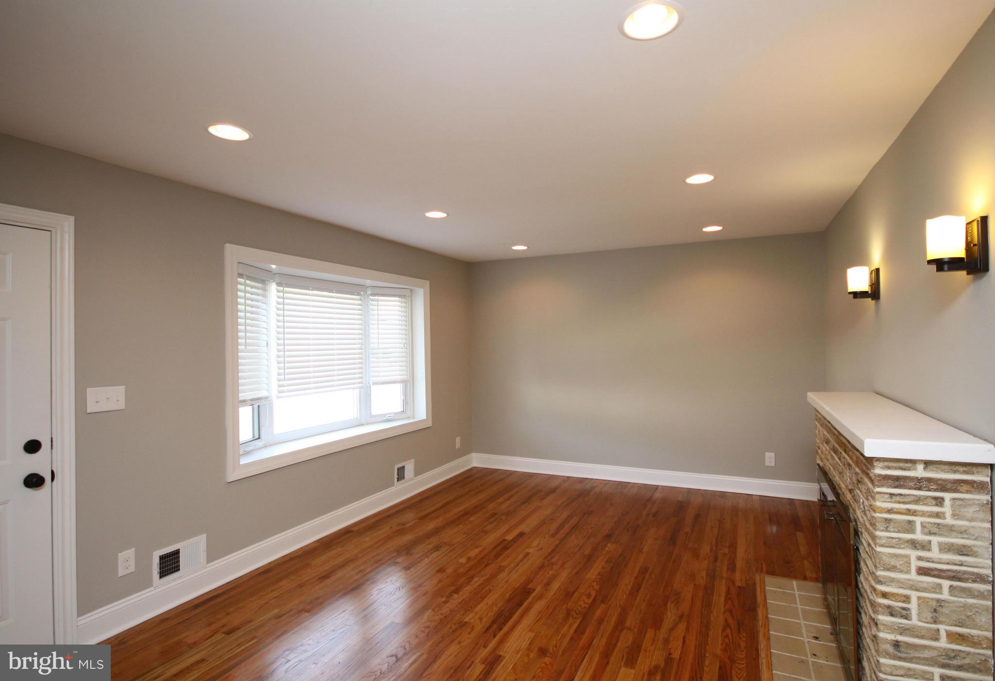 7103 Bexhill Road Baltimore, MD 21244 - Photo 8 of 30 an empty room with wooden floor and windows