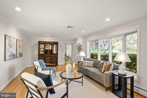 a view of a dining room with furniture wooden floor and chandelier