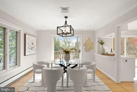 a view of a dining room with furniture wooden floor and chandelier