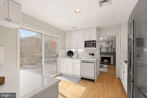 a living room with furniture a mirror and a window