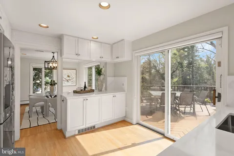 a living room with furniture large window and wooden floor