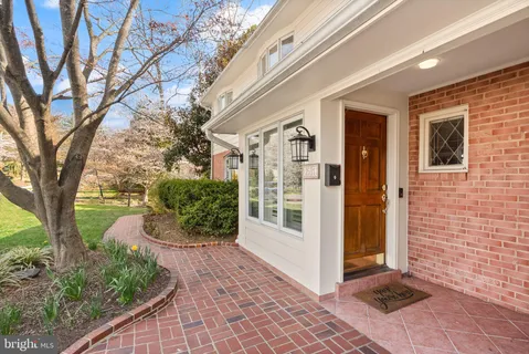 a view of a hallway to a house with wooden floor and stairs