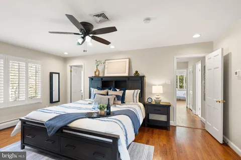 a bedroom with a large bed and a large window with the outer view