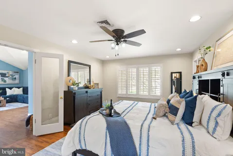 a vase of flowers sitting on a table with a potted plant