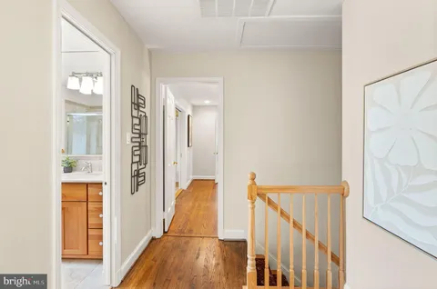 a living room with furniture a large window and a fireplace