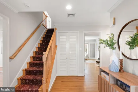 a view of a hallway with wooden floor and staircase