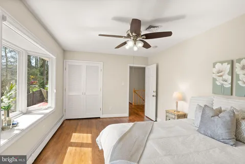 a living room with furniture a flat screen tv and a large window