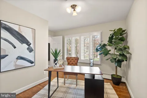 a bathroom with a sink a toilet a mirror and shower