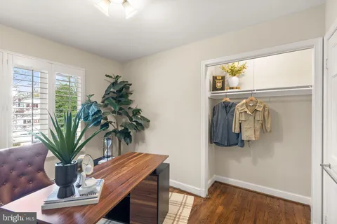 a view of a balcony with dining table and chairs