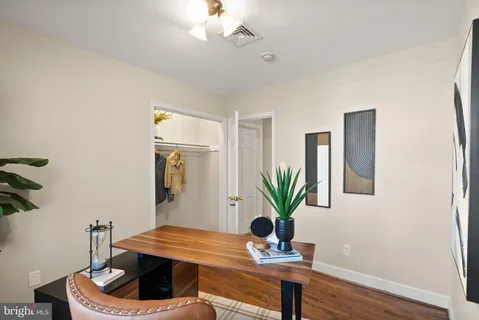 a view of a roof deck with table and chairs and wooden floor