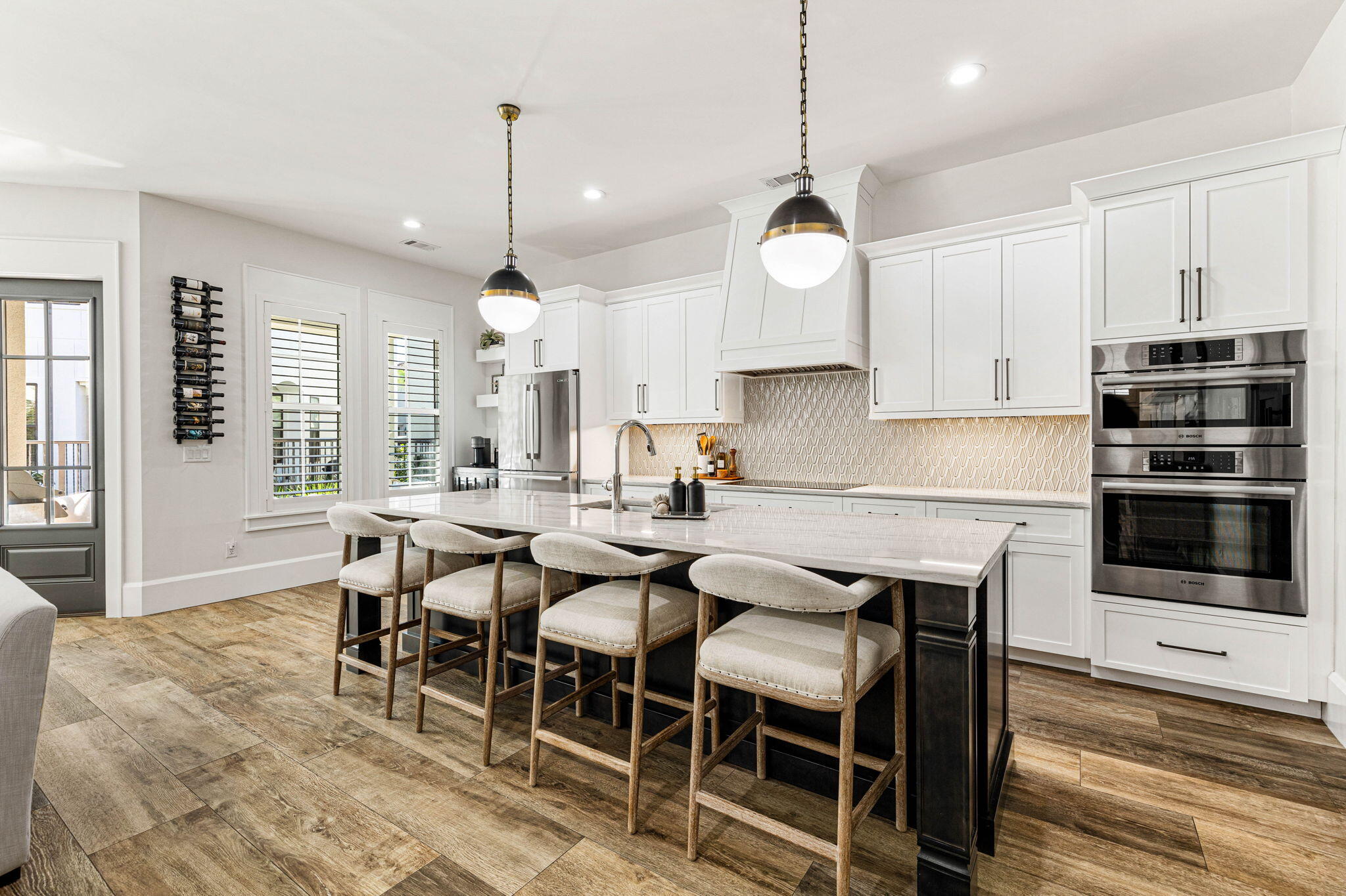 1980 Baytowne Loop Miramar Beach, FL 32550 - Photo 13 of 95 a kitchen with stainless steel appliances granite countertop a stove a sink a dining table and chairs with wooden floor