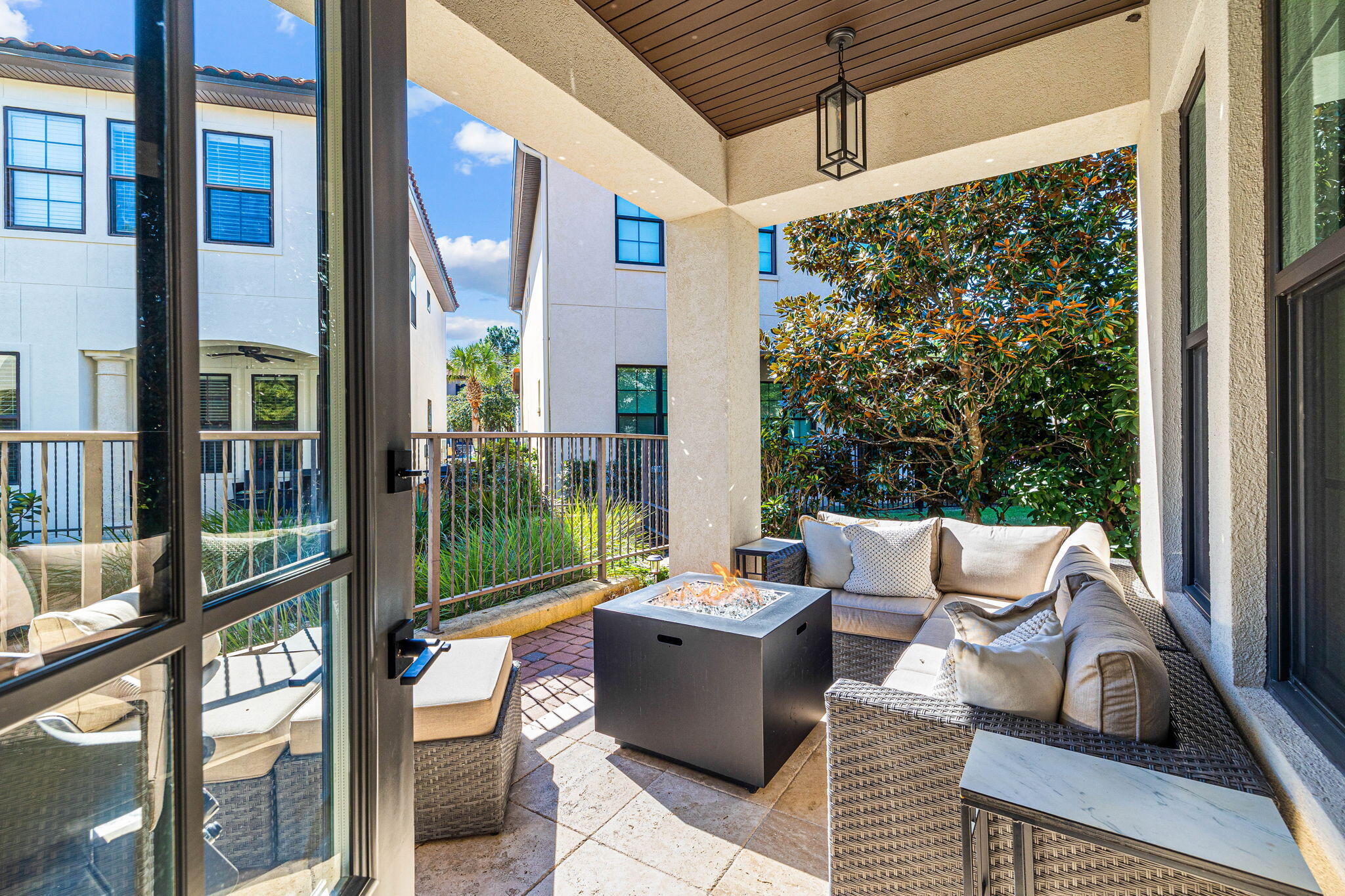 1980 Baytowne Loop Miramar Beach, FL 32550 - Photo 24 of 95 a view of a patio with couches chairs potted plants and floor to ceiling window and outside view