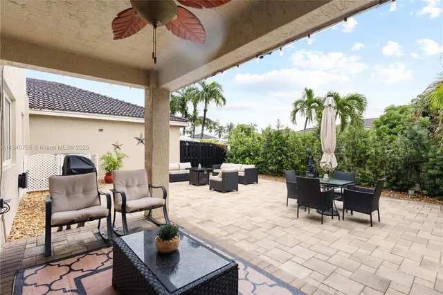 a living room with furniture a chandelier and a flat screen tv