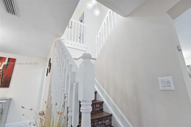 a view of a patio with dining table and chairs
