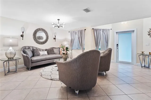 a living room with furniture a clock and a window