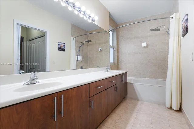 a view of a bathroom with a sink and mirror