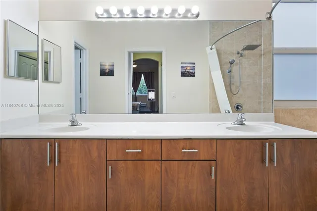a bathroom with a double vanity sink and mirror