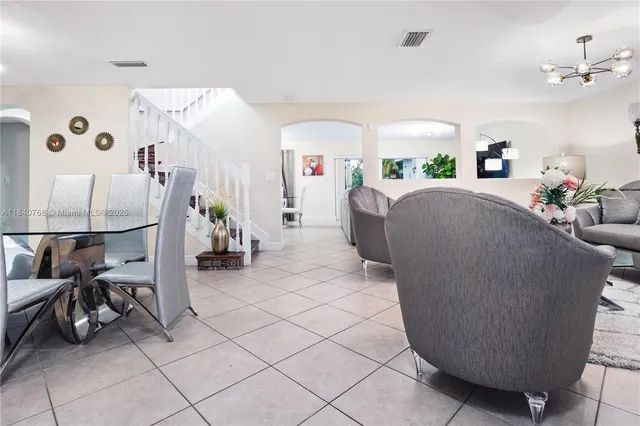 a living room with furniture and a lamp