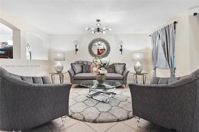 a living room with furniture and a chandelier