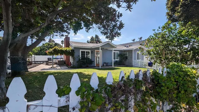 a front view of a house with swimming pool having outdoor seating
