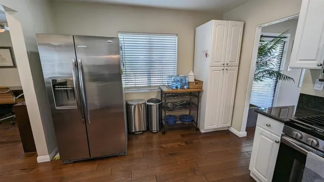a kitchen with stainless steel appliances a refrigerator and a stove