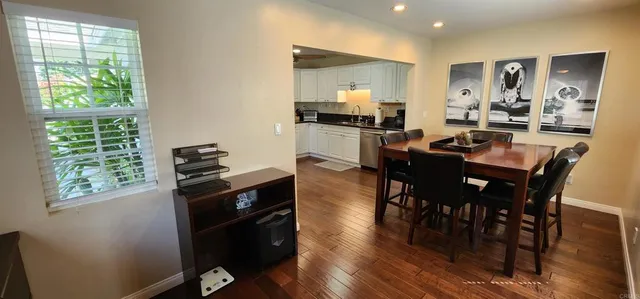 a view of a dining room with furniture window and wooden floor