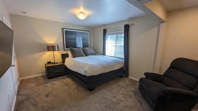 a bedroom with a bed and a couch