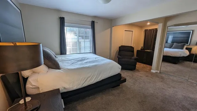 a bedroom with a bed and a couch