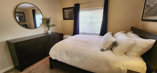 a bedroom with a bed and a mirror