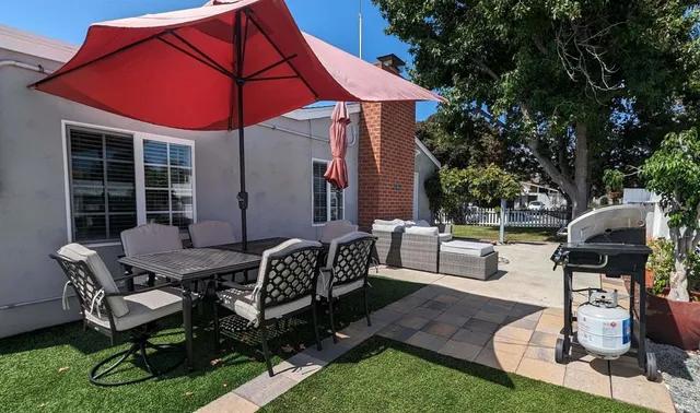 a patio with a table and chairs