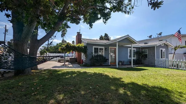 a view of a house with a yard and sitting area