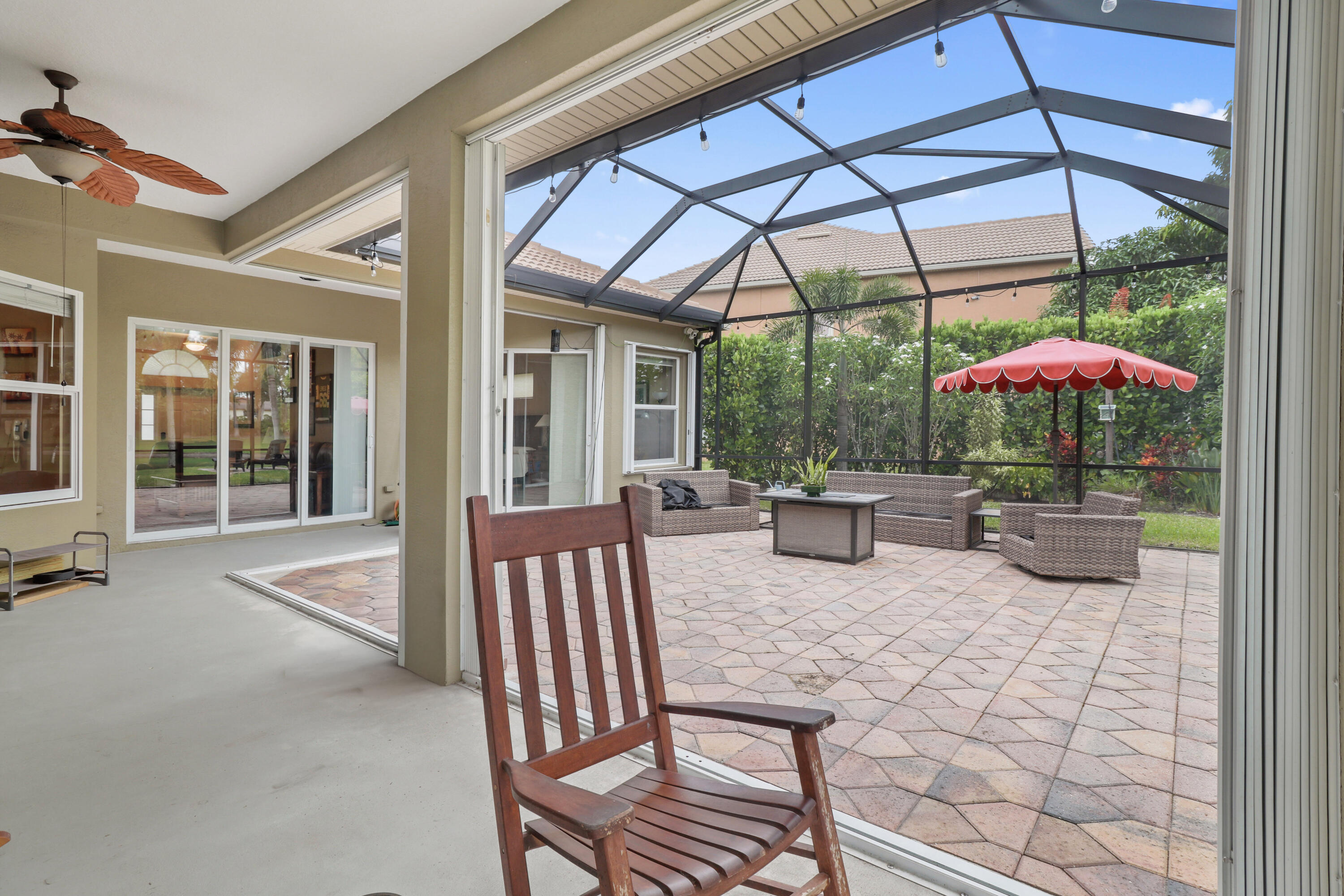 2242 Southwest Panther Trace Stuart, FL 34997 - Photo 55 of 63 a view of a patio with a table and chairs under an umbrella
