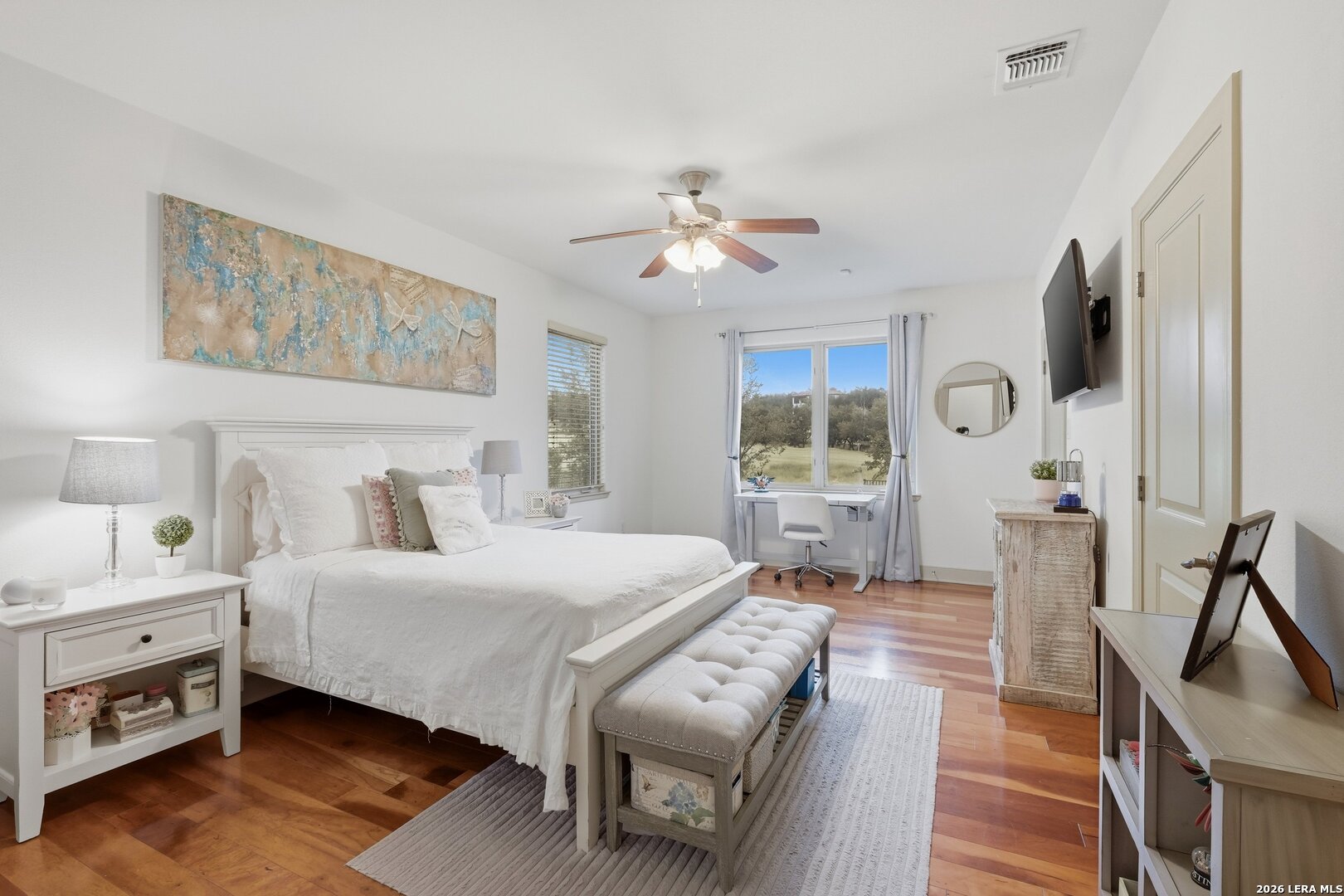 426 Legacy Ridge San Antonio, TX 78258 - Photo 21 of 38 a bedroom with a bed and wooden floor