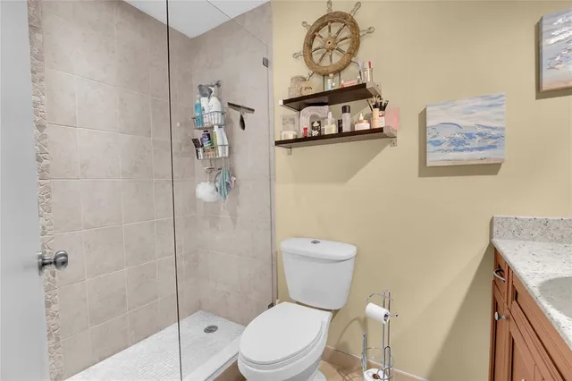 a swimming pool with lawn chairs and wooden floor