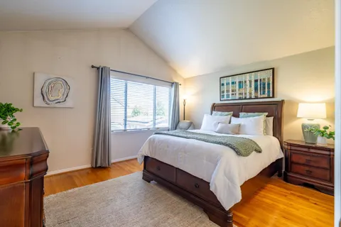 a bedroom with a bed and a window