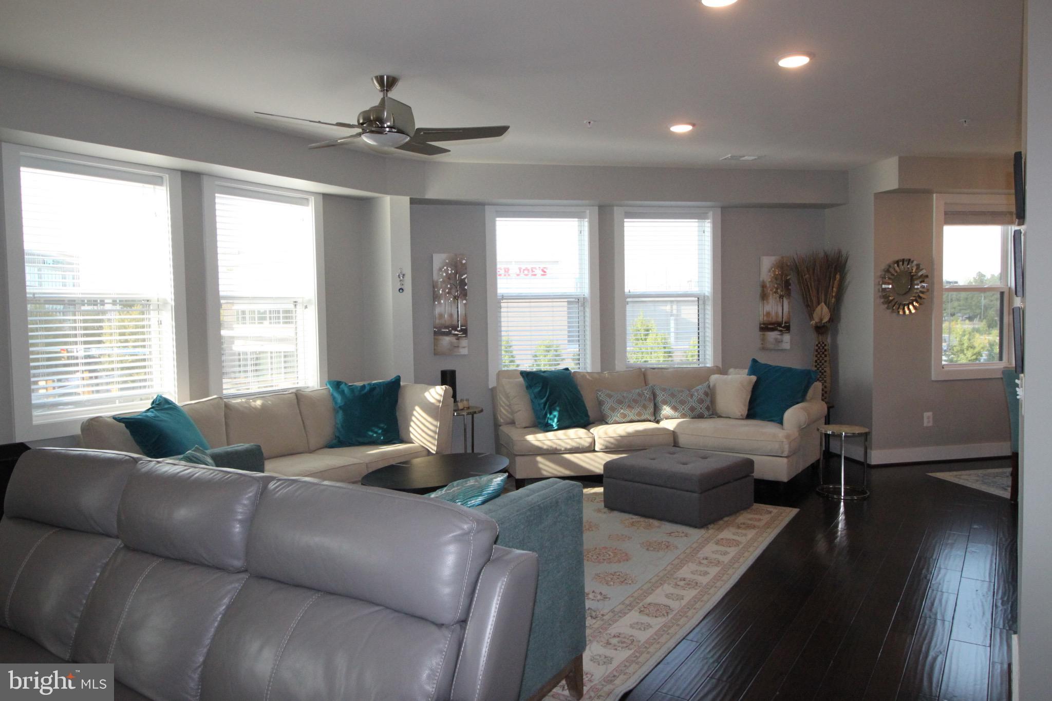 44738 Tiverton Square Ashburn, VA 20147 - Photo 18 of 66 a living room with furniture and a large window