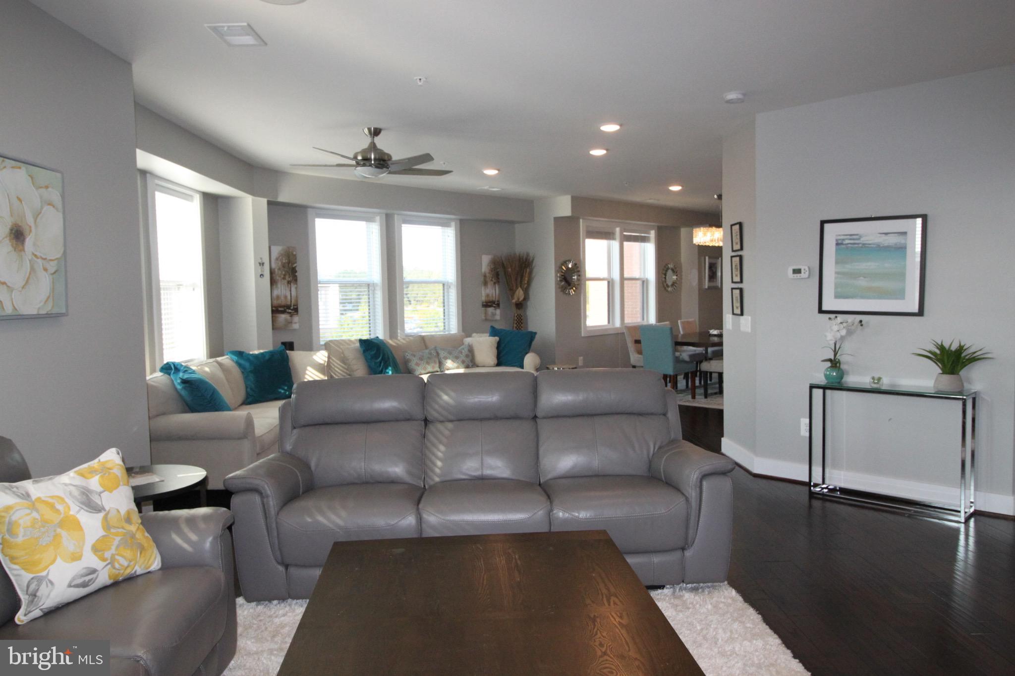 44738 Tiverton Square Ashburn, VA 20147 - Photo 19 of 66 a living room with furniture and a large window