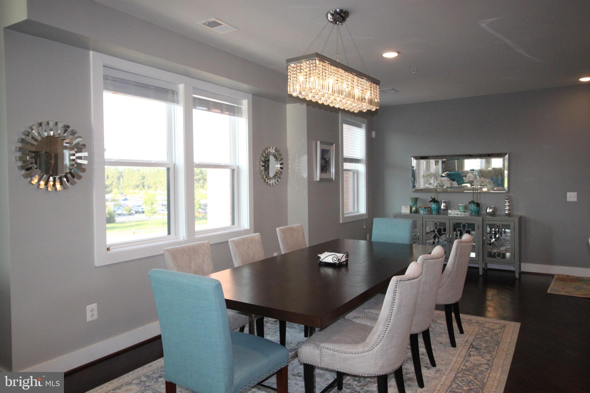 44738 Tiverton Square Ashburn, VA 20147 - Photo 26 of 66 a view of a dining room with furniture and wooden floor