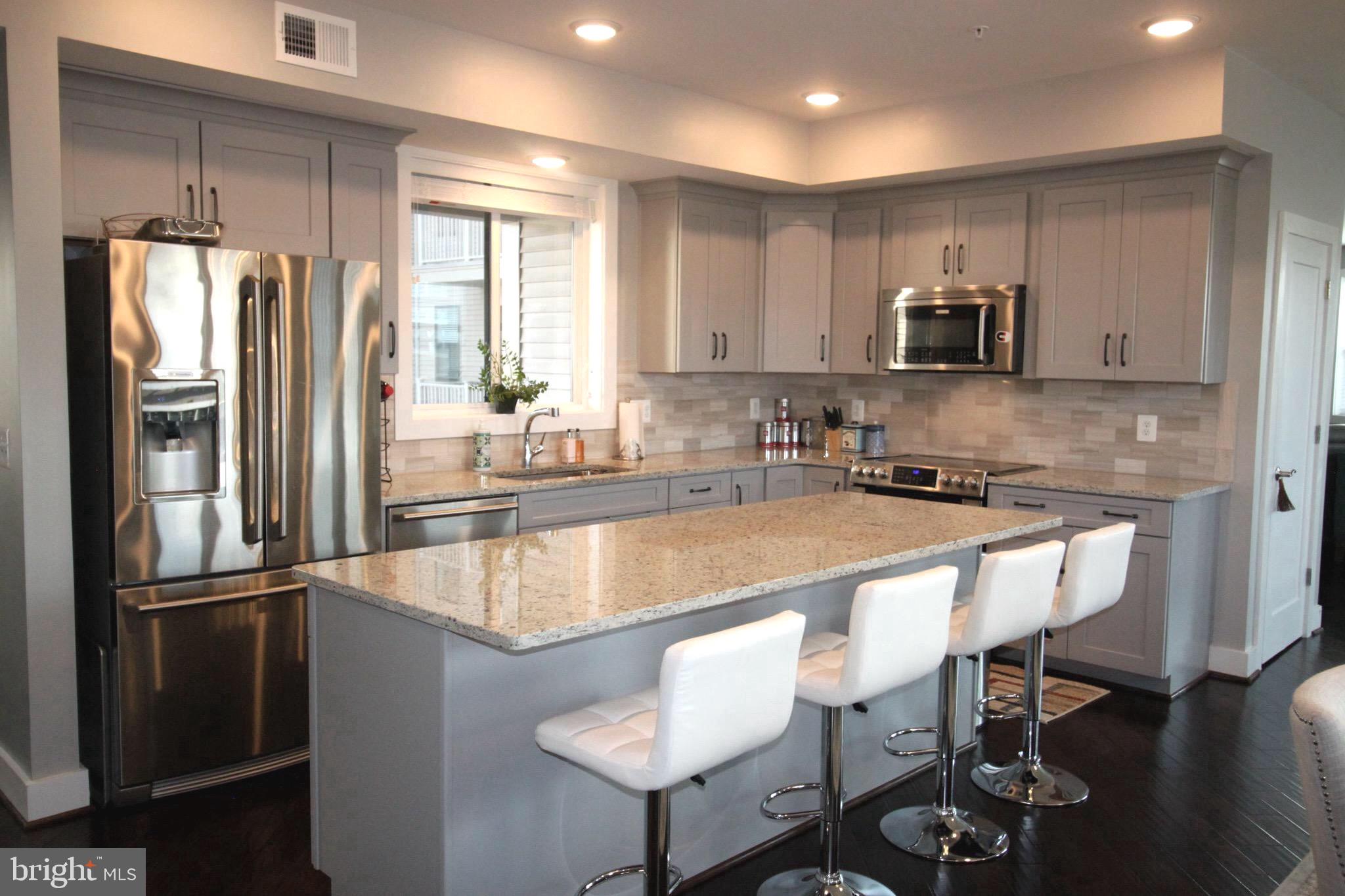 44738 Tiverton Square Ashburn, VA 20147 - Photo 3 of 66 a kitchen with stainless steel appliances granite countertop a refrigerator a sink and a stove